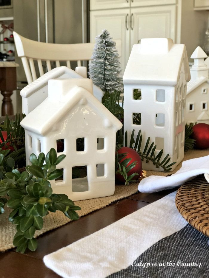 Minimal Christmas village with cream ceramic houses and miniature evergreen trees