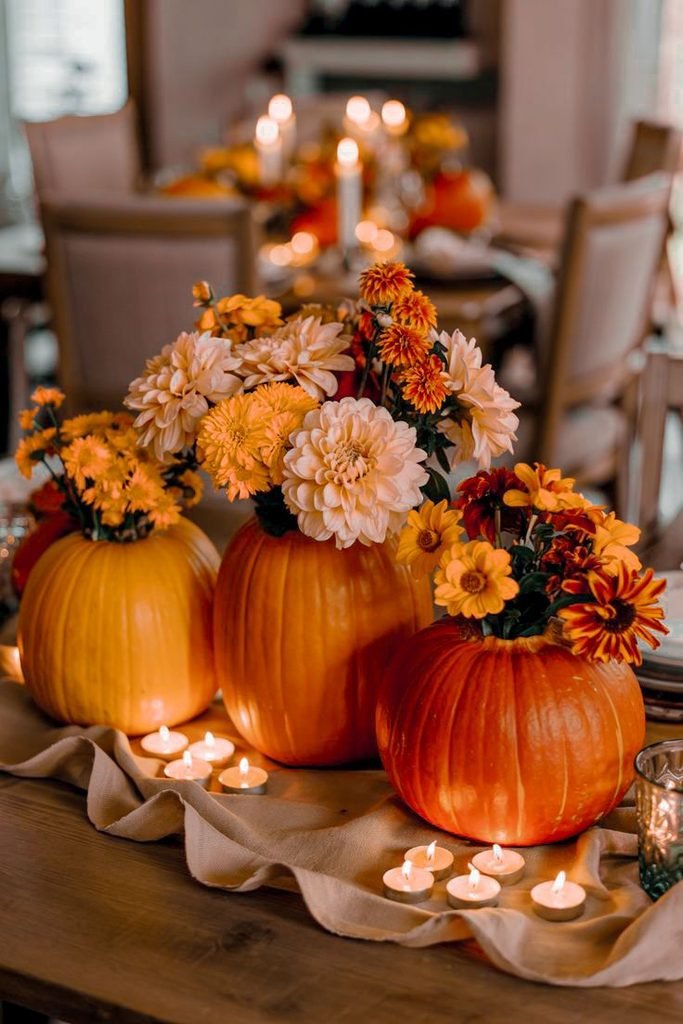 Fall floral pumpkin centerpiece with seasonal flowers and foliage