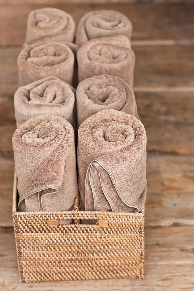 Rolled hand towels styled beside bathroom sink