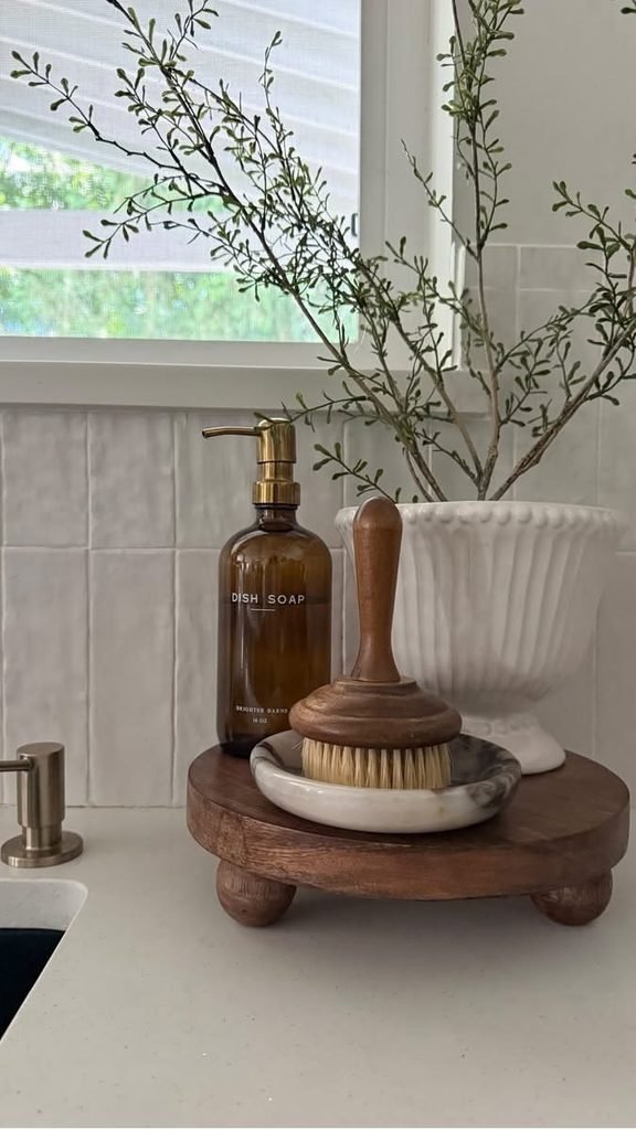 Layered countertop decor beside bathroom sink