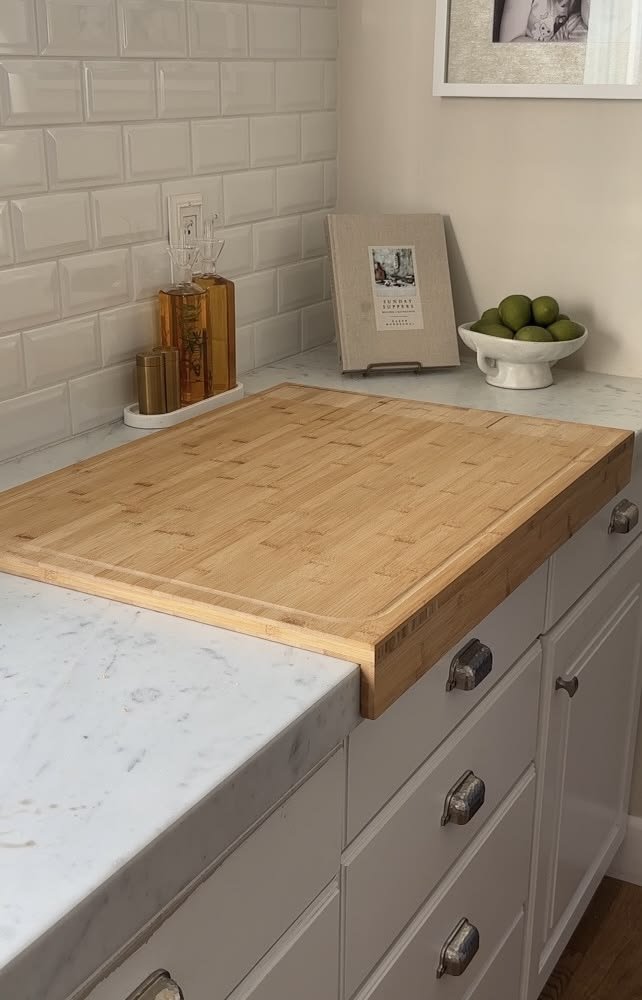 Leaning against backsplash, layered with smaller board 