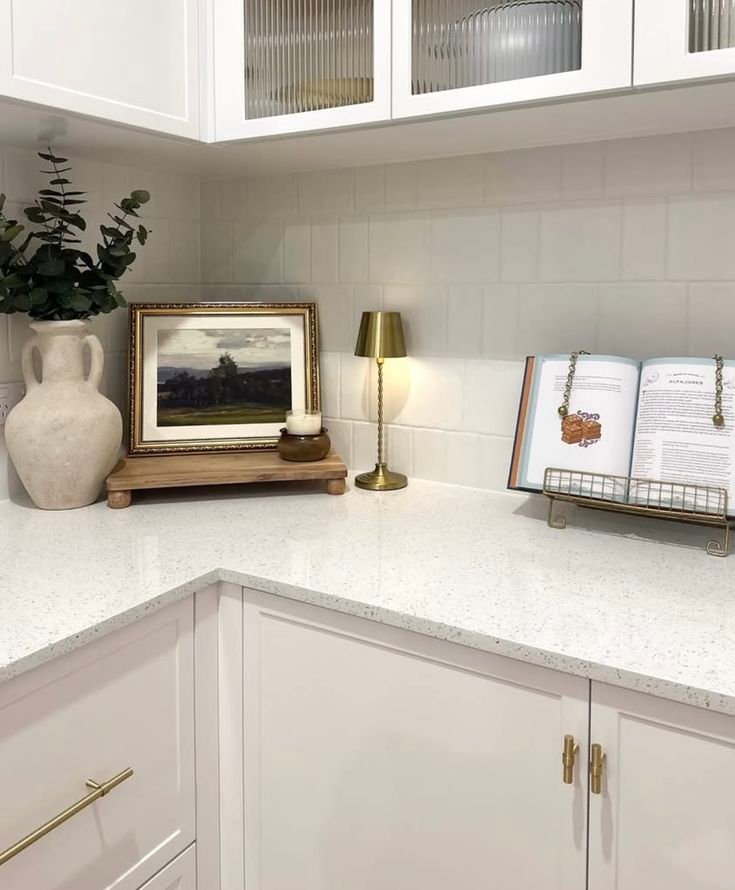 Artwork leaning against backsplash