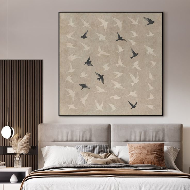 Bedroom with large framed artwork displayed above the bed