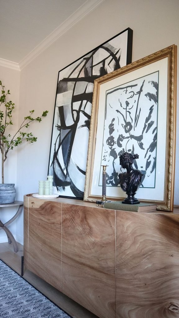 Framed artwork leaning against the wall on an entryway table