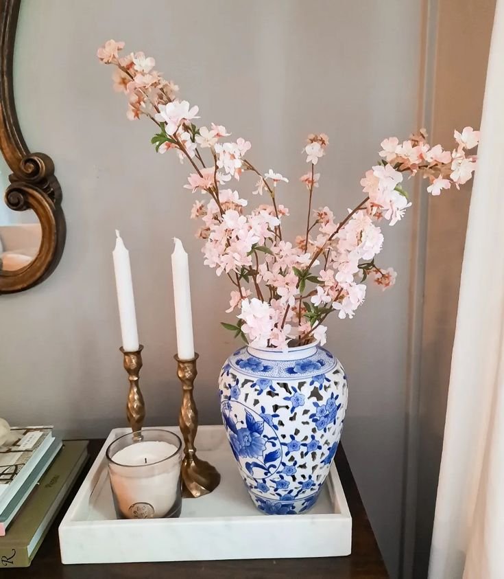 Seasonal branches displayed in a ceramic vase on an entryway table