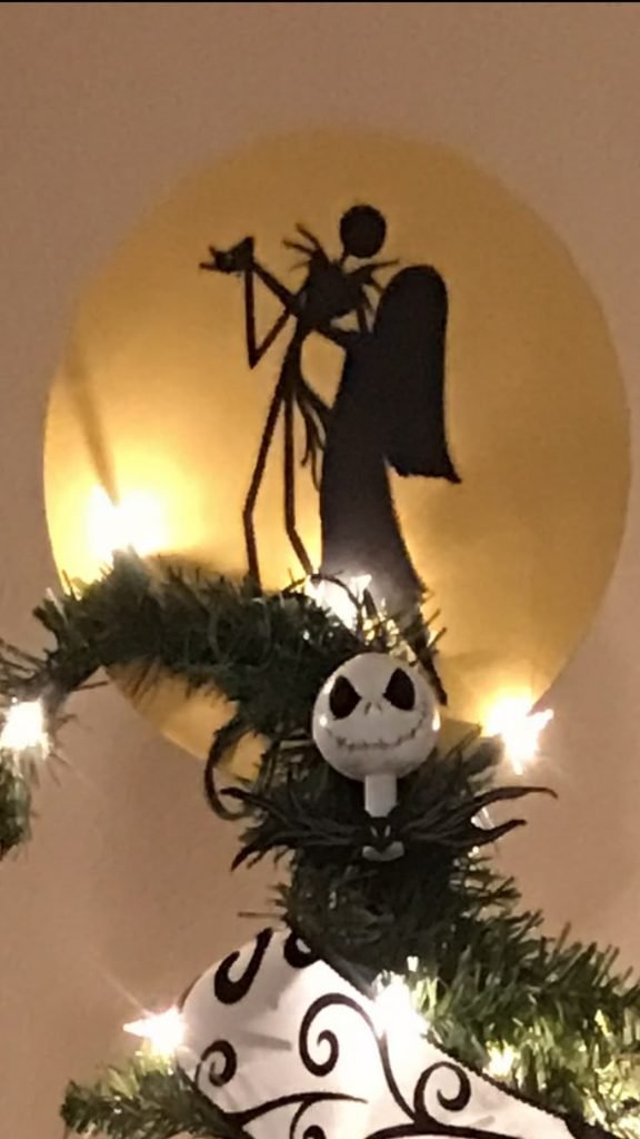 Spiral Hill inspired black tree topper on a Nightmare Before Christmas Christmas tree