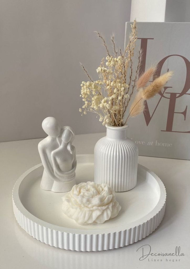 Sculptural ceramic object displayed on top of a toilet tank