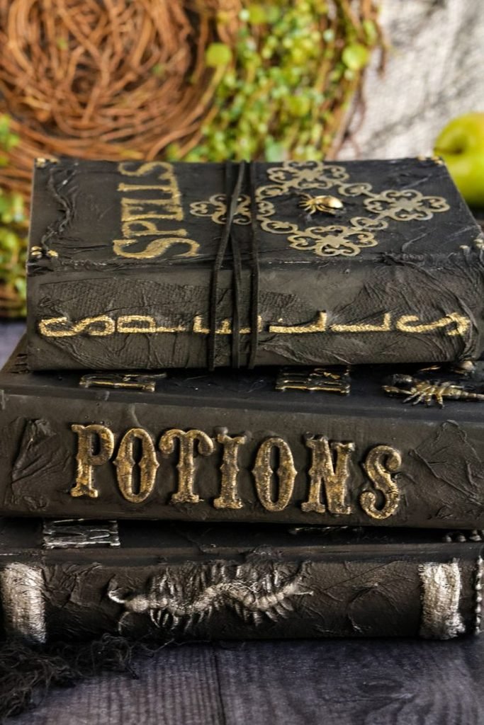 DIY Halloween book stack decor with pumpkin and dried branch