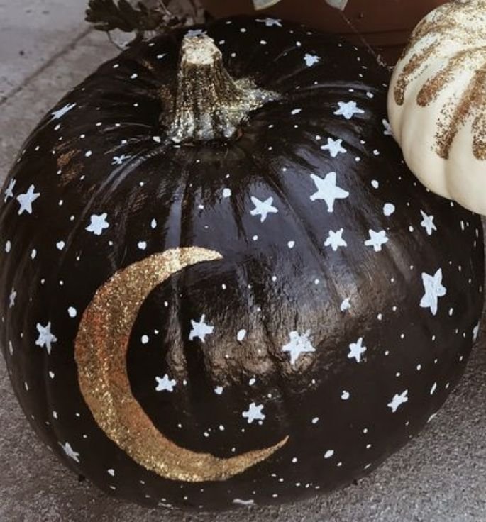 Navy pumpkin painted with moons and stars