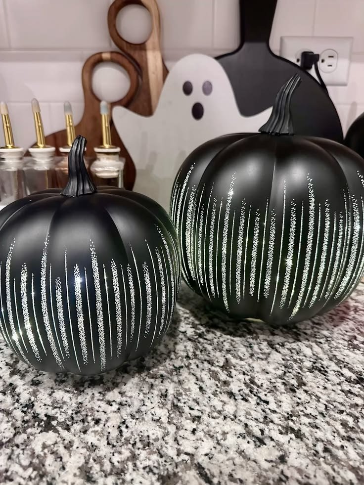 Matte black gothic painted pumpkin on a mantel