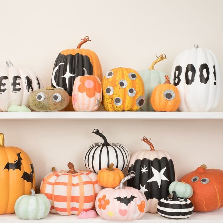 Mixed collection of painted pumpkins on a Halloween mantel