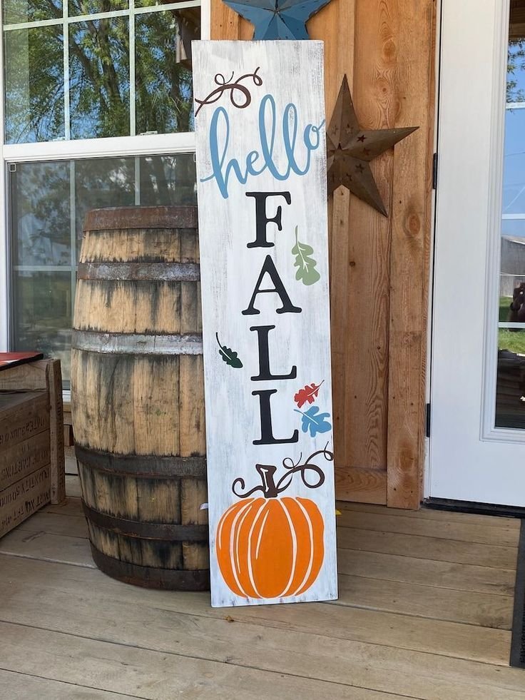 Vintage wooden fall sign with pumpkins and dried wheat