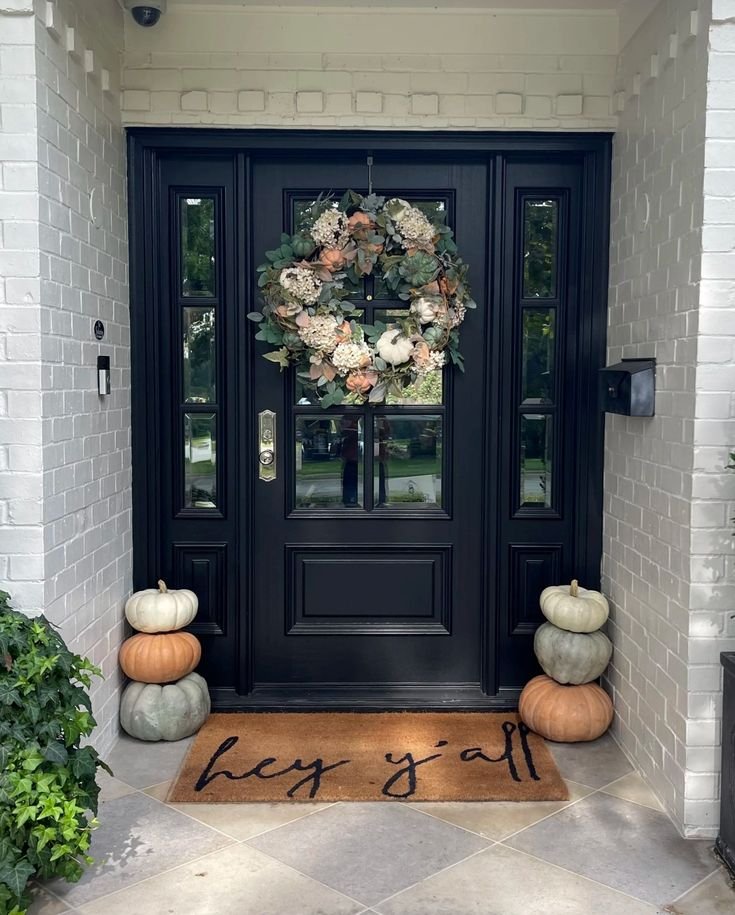 Simple fall porch with a statement wreath and pumpkins