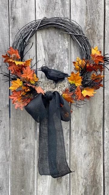Vintage-inspired Halloween wreath with a black raven and dark dried flowers.