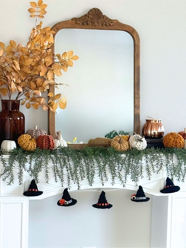Halloween fireplace mantel with a miniature witch hat garland and crescent moon.