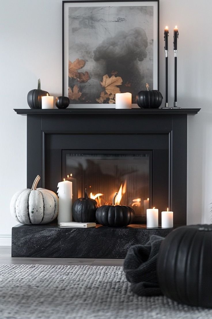 Modern Halloween mantel with sculptural black ceramic pumpkins and dried foliage.