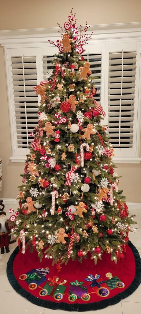 Gingerbread Christmas tree with miniature gingerbread ornaments, cream bows and candy canes.