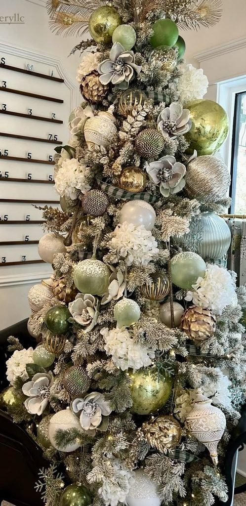 Olive green and cream Christmas tree with velvet ribbons and antique brass ornaments.