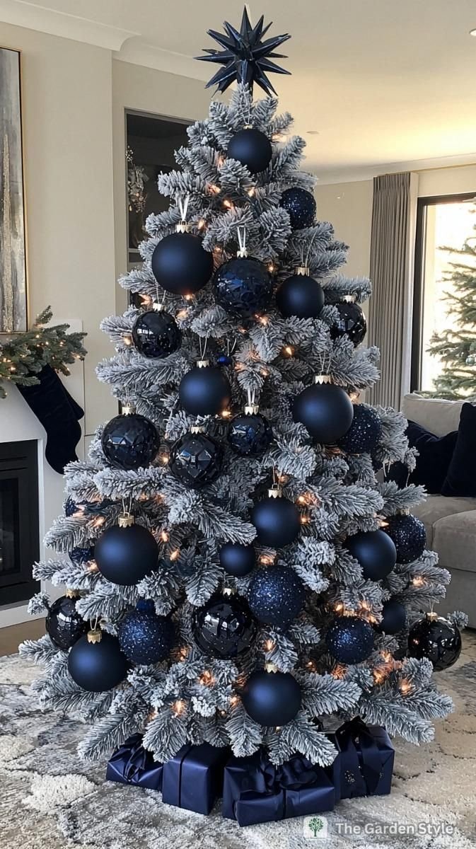 Midnight blue and silver Christmas tree with navy velvet bows and glass icicle ornaments.
