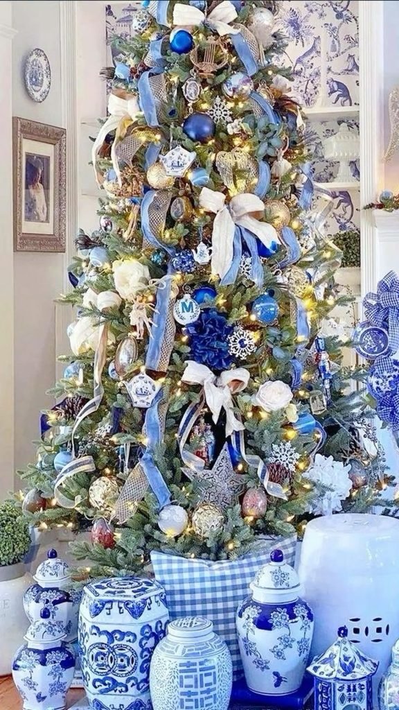 Blue and white Delft-inspired Christmas tree with patterned porcelain ornaments and cobalt ribbons.