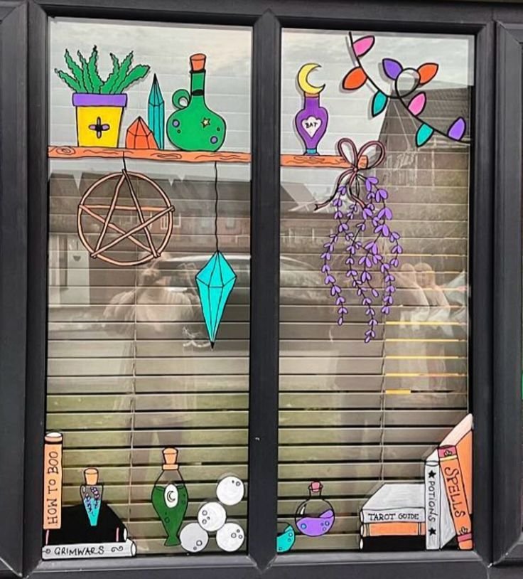 Colorful witch potion bottles painted on a Halloween window