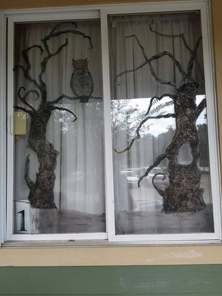 Creepy black tree branches painted on a Halloween window