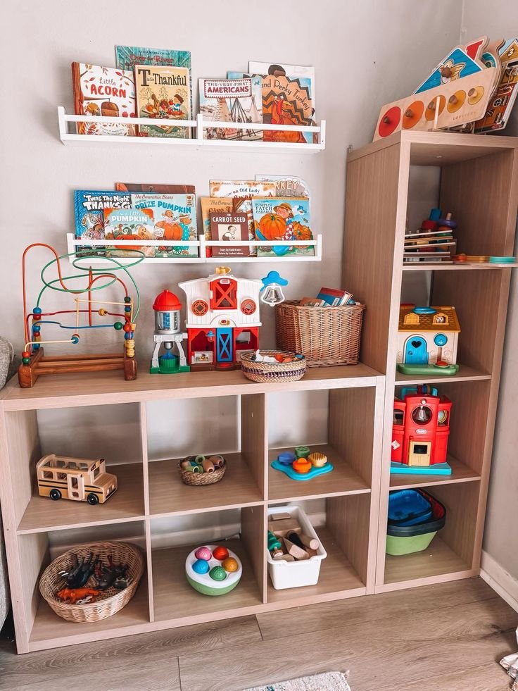 Organized children's playroom with low wooden shelves and colorful toy bins