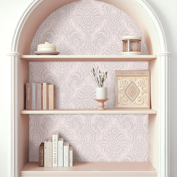 Elegant damask wallpaper behind dark wood shelves with books, ceramics, and brass accents