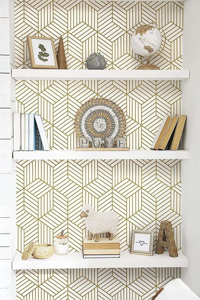 Modern shelves with black and cream geometric wallpaper and simple decorative objects