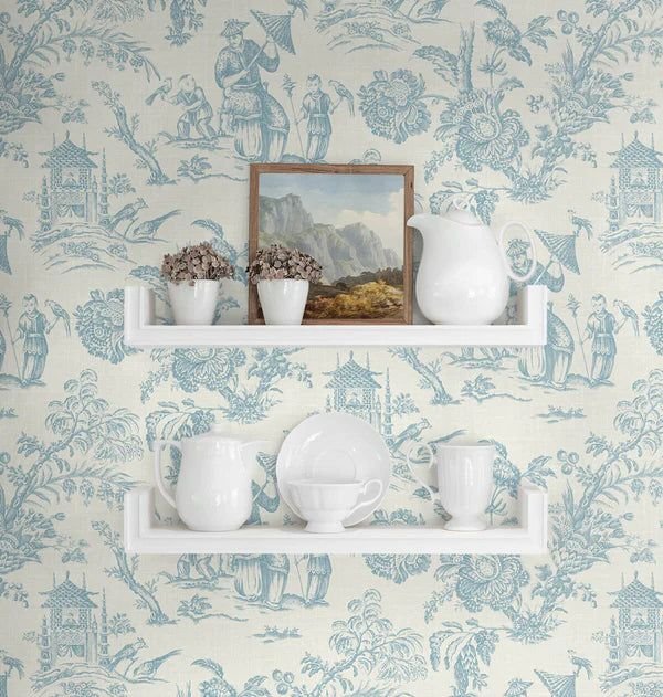 Chinoiserie wallpaper with birds and branches behind shelves with ceramic and brass decor