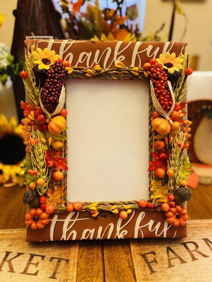 Framed Thanksgiving artwork displayed with pumpkins and autumn branches