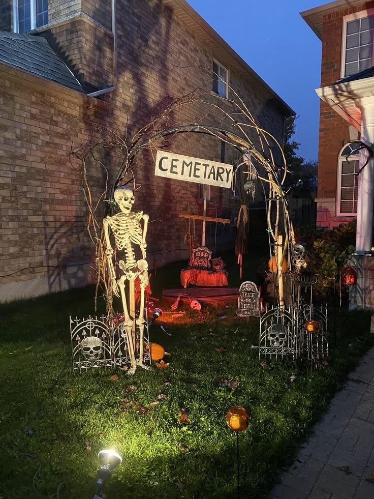Layered Halloween graveyard display with tombstones and skeletal hands.